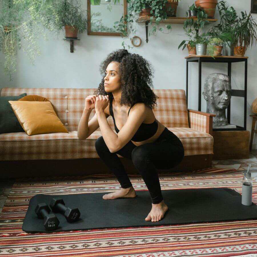 Woman doing a short home workout to stay consistent with exercise