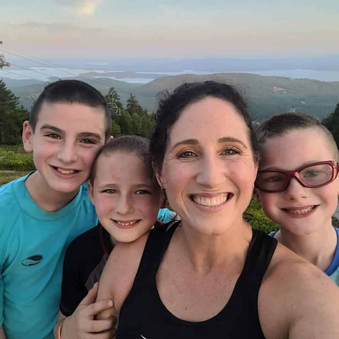 Heather with three of her kids on a mountaintop