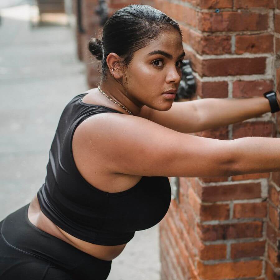 Woman performing beginner wall push-ups at home