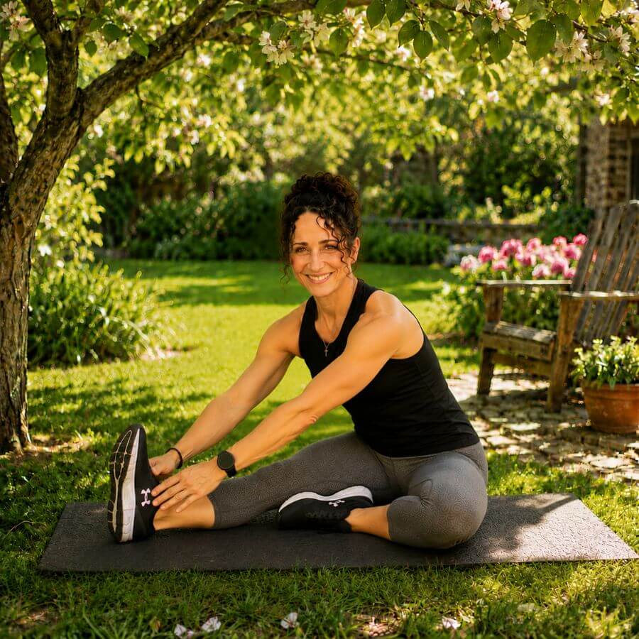 Woman stretching after a home workout recovery session